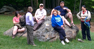 Adults sitting on a rock and being boring