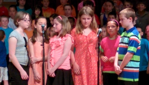 Alpha and five other students sing the opening to a song during their school concert